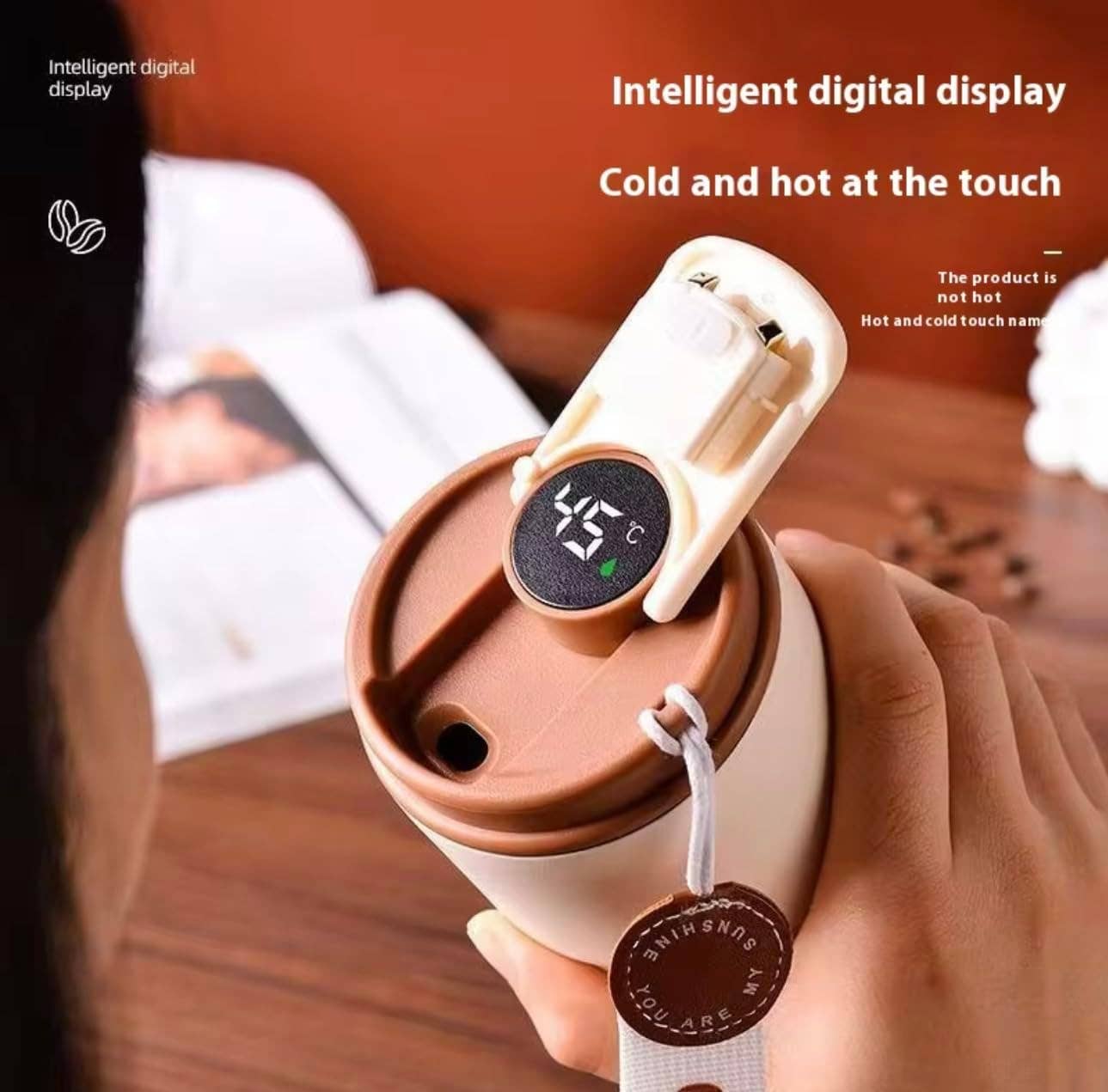 Coffee cup with digital temperature display held by a person, with text about intelligent digital display.